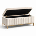 Panca contenitore in tessuto beige con gambe in metallo dorato